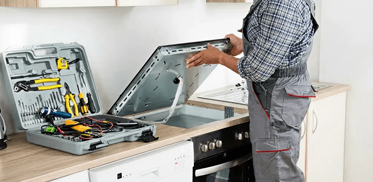 Handyman repairing a cooktop and checking wiring connections in Yonkers, NY