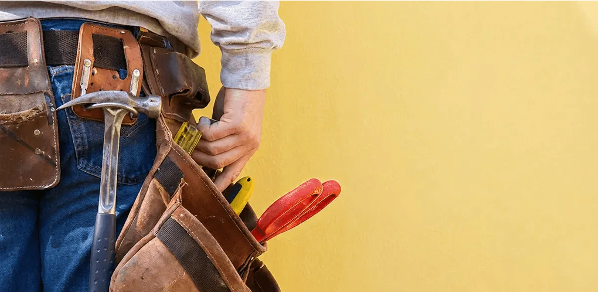 Handyman with tool belt ready for home repairs and maintenance in Yonkers, NY