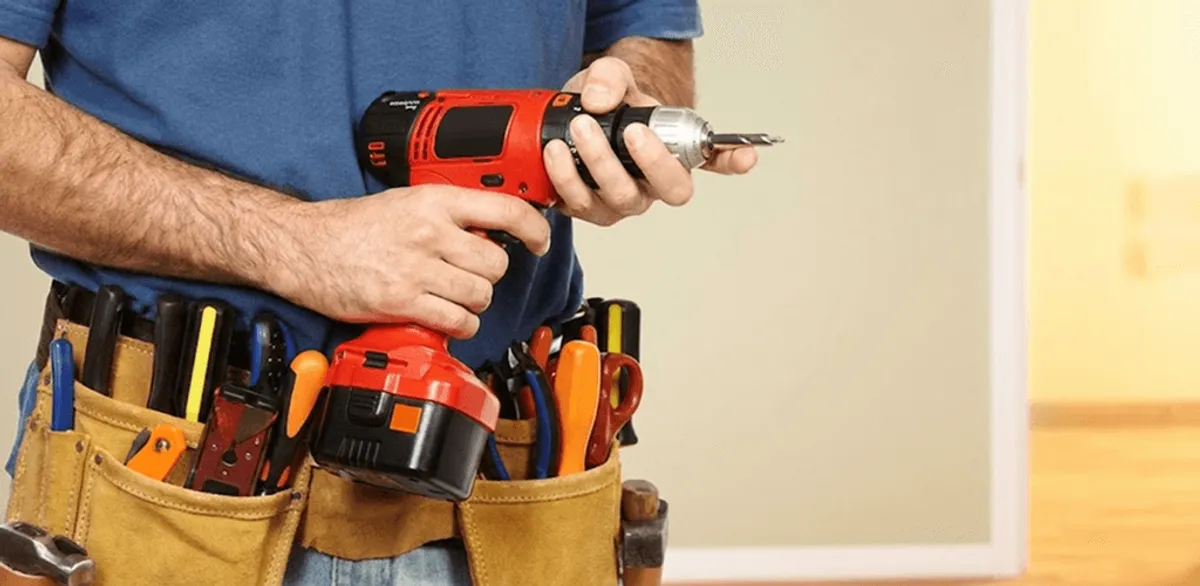 Handyman holding a power drill for home repairs and installations in Yonkers, NY